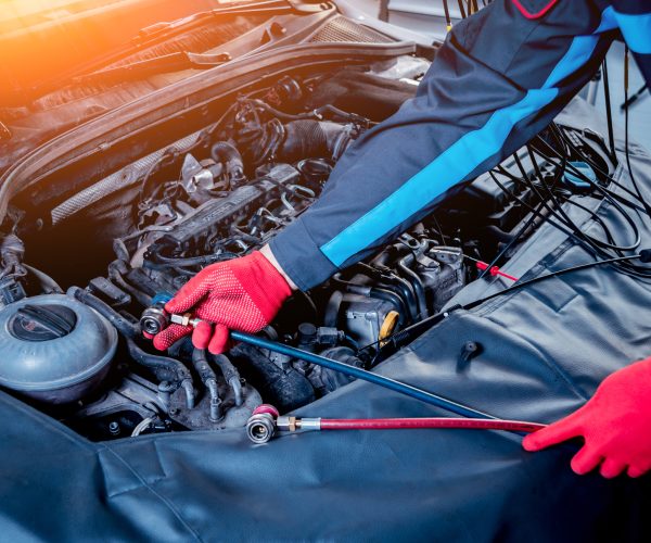 Servicing car air conditioner. Service station. Car repair.